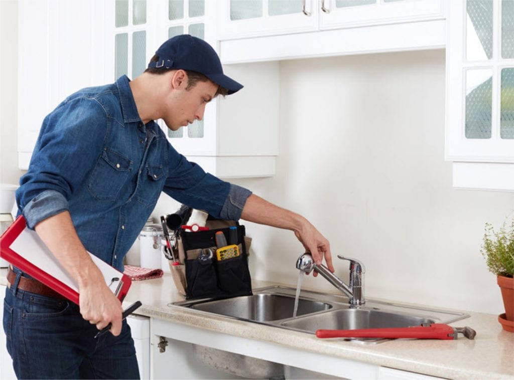 A handyman working on a faucet